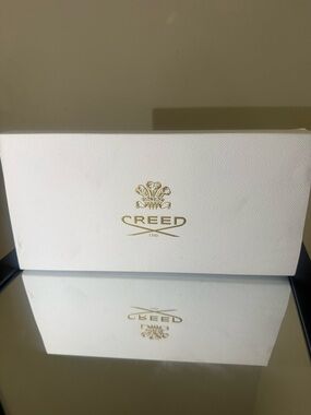 Creed White Box with Gold Accent Text